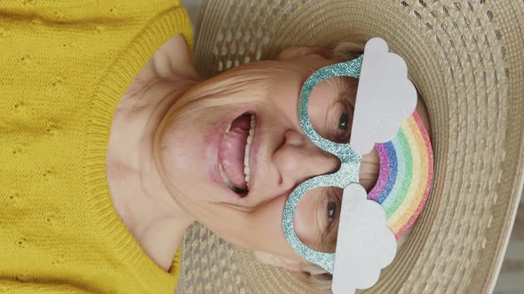 Goodlooking Elderly Caucasian Woman with a Hat and Funny Glasses Medium Closeup Living Room Senior