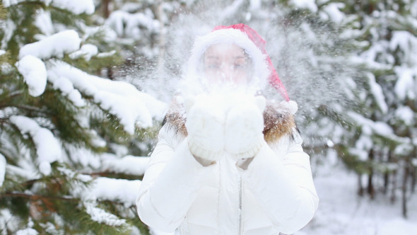 Happy Friendly Young Woman Blowing Snowflakes alt