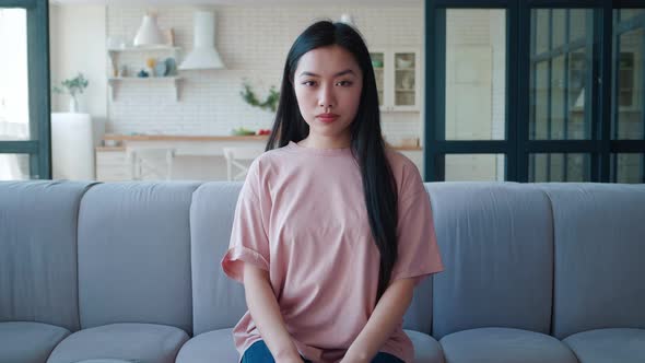 Portrait of Confident Beautiful Young Asian Woman Sitting at Couch at Home