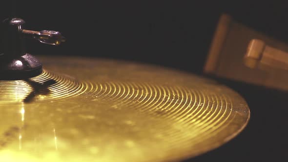 Two drum sticks hitting a cymbal