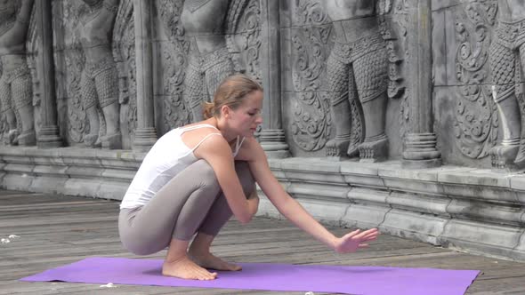 Woman Practicing Yoga During Yoga Retreat in Asia Bali Meditation Relaxation in Abandoned Temple