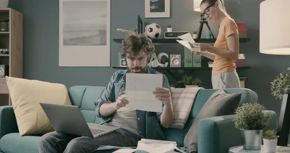 Couple checking bills and paperwork at home