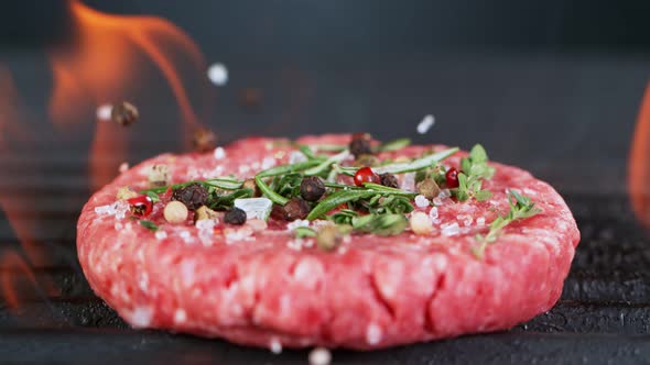 Super Slow Motion Shot of Falling Fresh Beef Hamburger Meat with Herbs on Grill at 1000 Fps