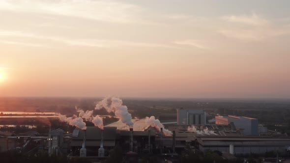 Aerial view Drone shot of flying around toxic chimneys tubing. Air Pollutants, Industrial zone.