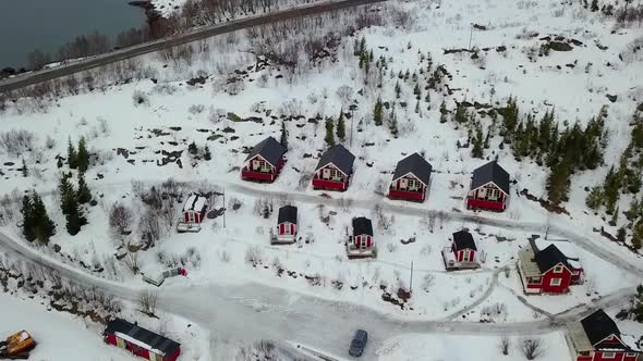 Traditional red Rorbu cabin with coastline at evening in winter, village in Lofoten Islands archipel