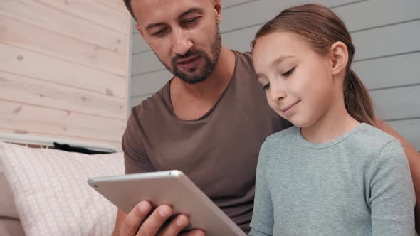 Father and Little Daughter Using Tablet