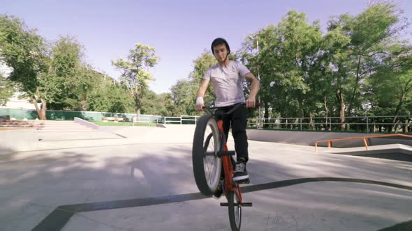 BMX Rider Doing Tricks in Extreme Park During Sunset Slow Motion