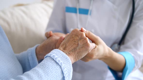 Doctor Keeping Hands Of Senior Patient. Closeup. Health Care/Medical Assistance.