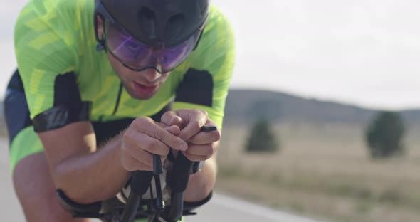 Closeup Shot of Triathlon Sportsman Athlete Cyclist Riding Professional Racing Bicycle