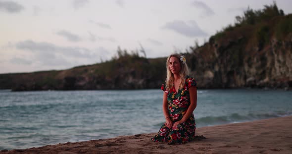 A young girl runs to hug her mothers open arms on a tropical beautiful beach durning a gorgeous summ