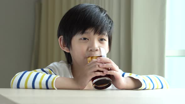 Little Asian Boy Drinking Soft Drink Cola Soda