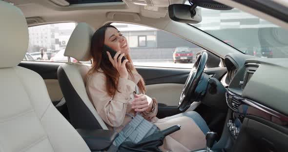 Smiling Positive Brunette Woman Sitting in Car Giving Commands to Voice Assistant Living Voice