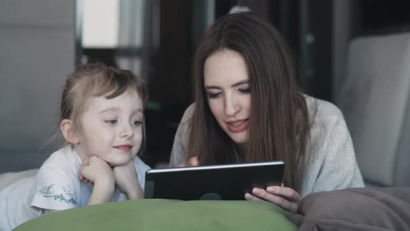 Happy Family Young Mum And Cute Little Kid Daughter Use Digital Tablet Technology Device