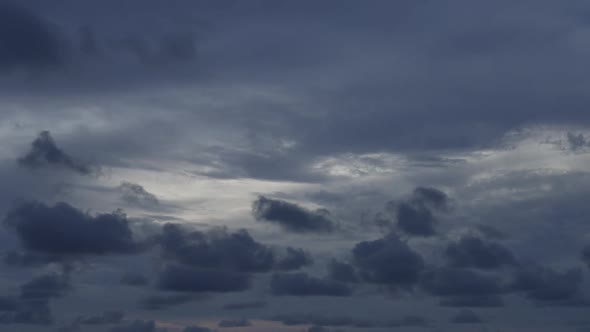 Timelapse of the Evening Blue Sky with Purple Clouds Floating Across the Sky and a Light Layer of