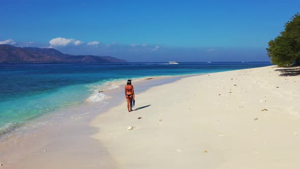 Young beauty models on vacation enjoying life on beach on summer white sand and blue background 4K