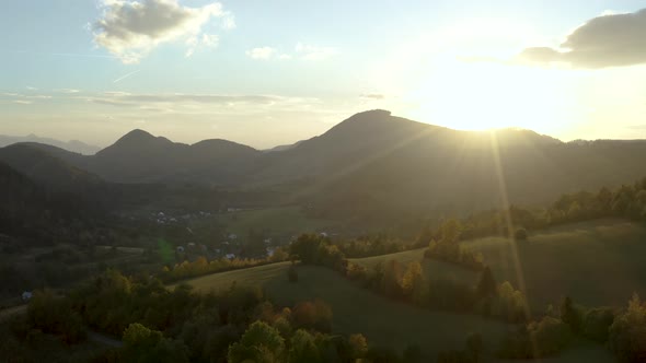 Flying over the mountains in sunset