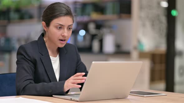 Excited Indian Businesswoman Celebrating Success on Laptop in Cafe 