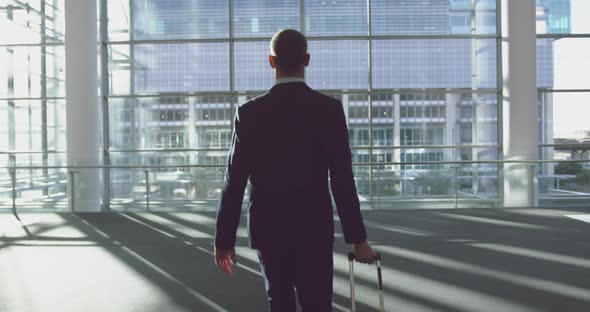 Businessman standing with luggage in the lobby at office 4k