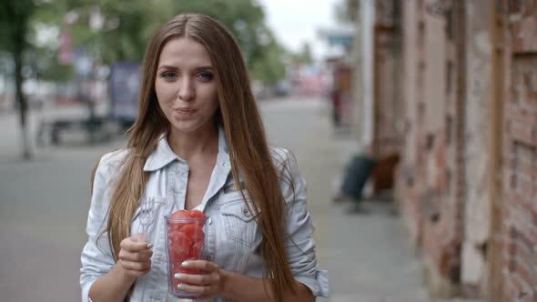 Attractive Young Woman Eating Watermelon