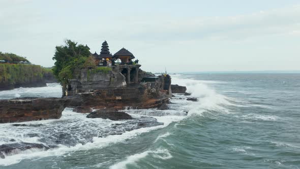 Tanah Lot Temple on Rocky Cliff in Bali Indonesia Pounded By Strong Waves From the Open Sea