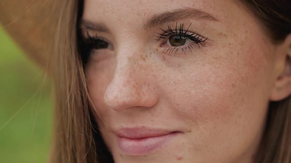 Close up of Ginger Freckled girl with Cheerful Smiling and Brown eyes.