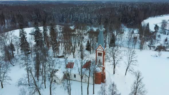 Aerial Top View of the Krimulda Evangelic Lutheran Church in Winter at Sunrise Latvia 4k Video