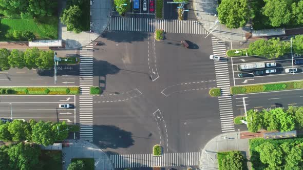Aerial Top Down View of an Intersection Crossroads with Traffic Moving Cars of Different Colors and
