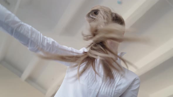 Attractive Cheerful Woman Dancing on Bed and Singing with Comb Like Microphone at Home