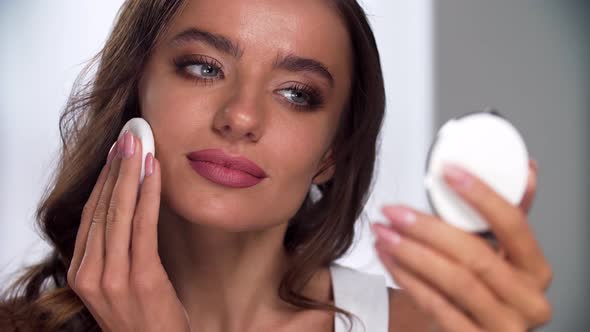 Face Makeup. Woman Applying Powder On Skin With Sponge Closeup