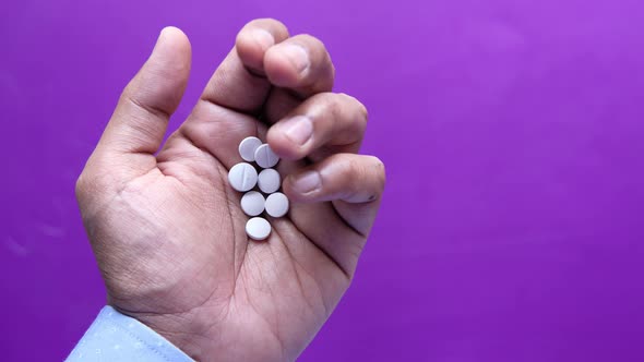 Close Up of Man Hand Taking Medicine 