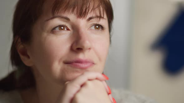 happy brunette woman dreams, remembers pleasant life events