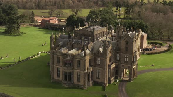 parallax drone shot of castle mansion on sunny day