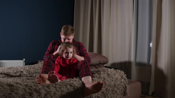 Dad Braiding His Daughter's Hair