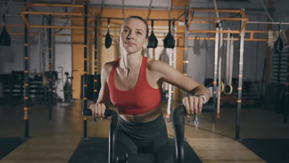 Young Woman Trains on Exercise Bike