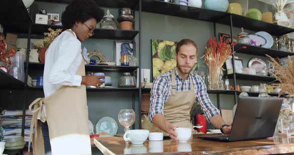 Mixed Race Sellers which Working Together in Small Cozy Gift Shop