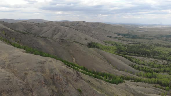 A Drone Flies Over the Ridge. Desert or Steppe Landscape. Mountains of the Southern Urals - Nurali