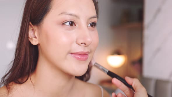Young asian woman in bedroom. Make-up artist in beauty studio
