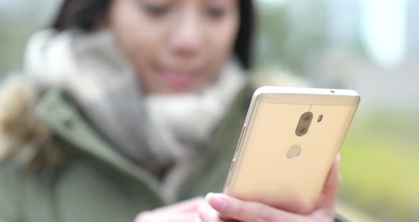 Woman use of mobile phone in outdoor park