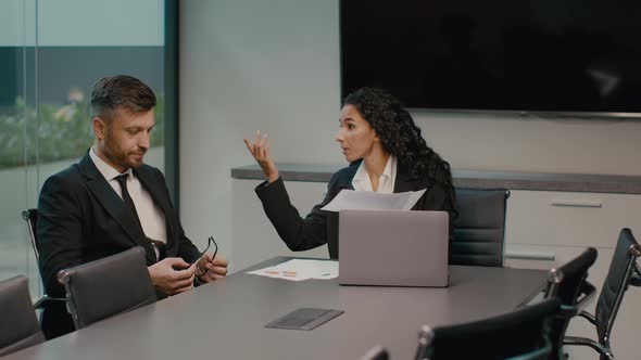 Angry Businesswoman Shouting At Male Employee At Workplace Indoor