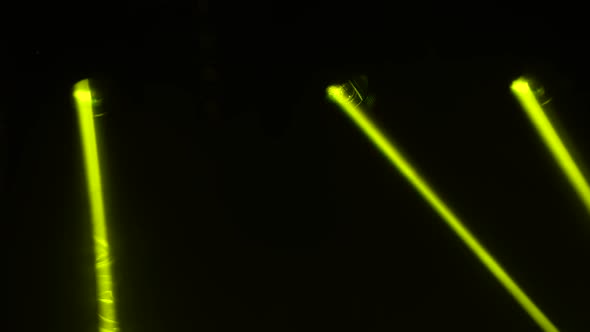 Yellow Laser Lights Revolve and Move Over Dark Stage