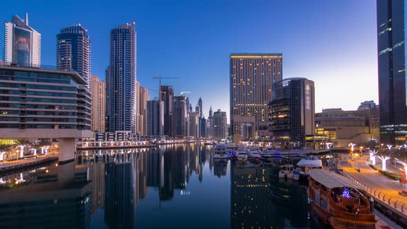 View of Dubai Marina Towers and Canal in Dubai Night to Day Timelapse