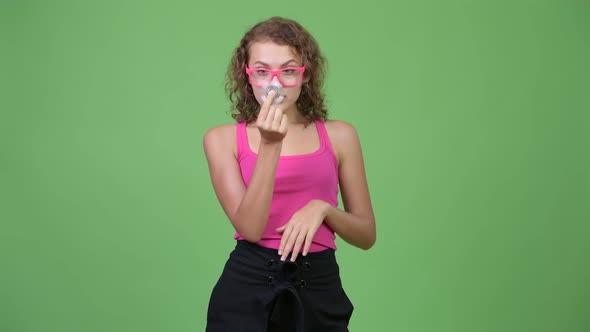 Young Beautiful Nerd Woman Playing with Fidget Spinner and Looking Amazed