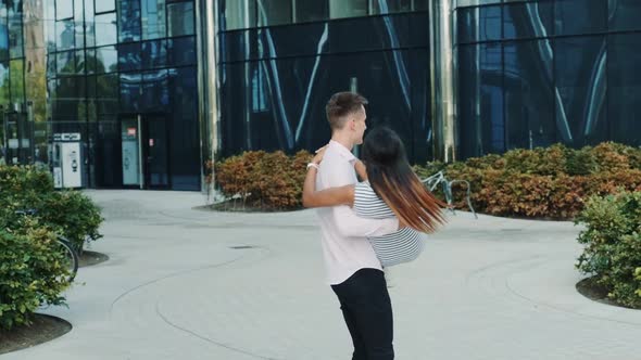 Handsome Man Holding Black Woman in His Arms and Spinning Around