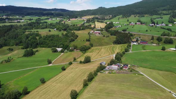 Countryside farmland at hillside in Byrkjelo Norway - Summer day aerial view