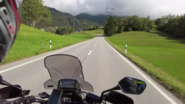 POV Biker Rides on Motorbike By Scenic Green Mountain Road Swiss Alp Moto Trip