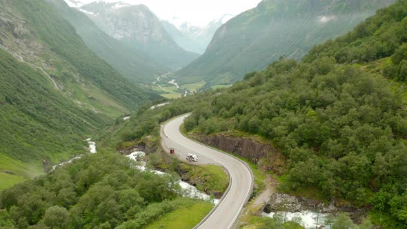 Aerial View Of Road In Mountains And Forest Landscape In Stryn, Norway - drone shot