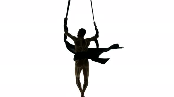 Man Dancer on Aerial Silk, Aerial Contortion, Aerial Ribbons, Aerial Fabric in Posing Exercise