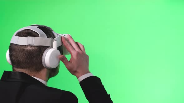 Man in Business Suit with Virtual Reality Glasses on Chromakey Background