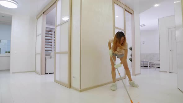 Young Woman Washing the Floor at Home