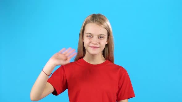 Girl Waves Her Hand Her Friends and Calls Them